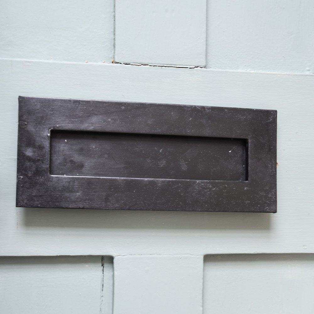 A Berkeley Letterplate in black beeswax in position on a front door