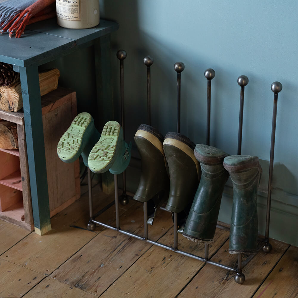 Welly boot holder for 6 pairs seen in a hallway