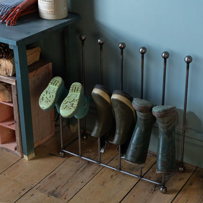 Welly boot holder for 6 pairs seen in a hallway