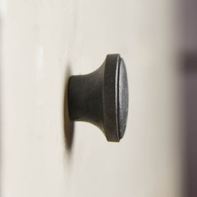 A side angle photo of the cabinet knob showing protrusion from cupboard door