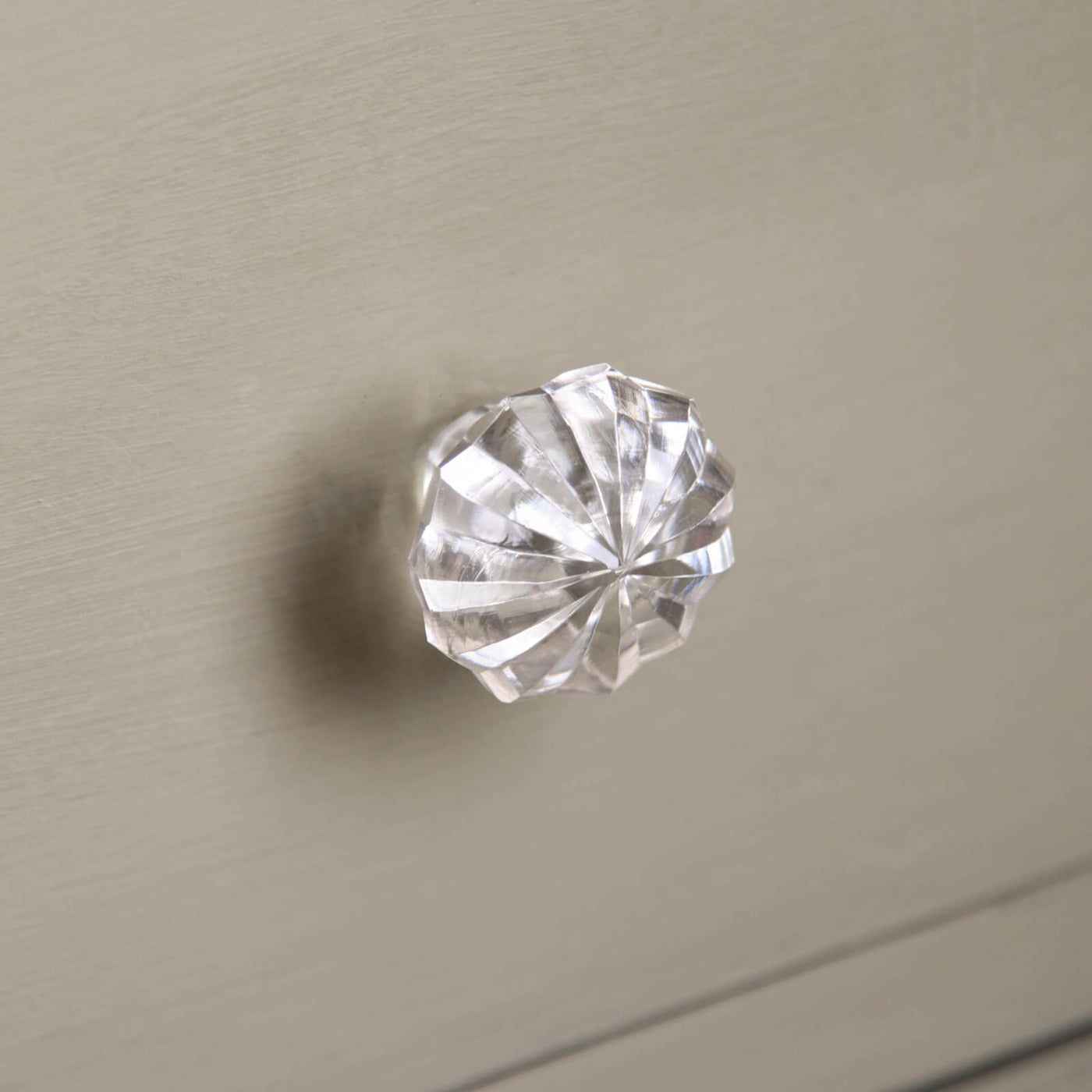 Glass Cabinet knob with fluted detailing on a set of green grey drawers