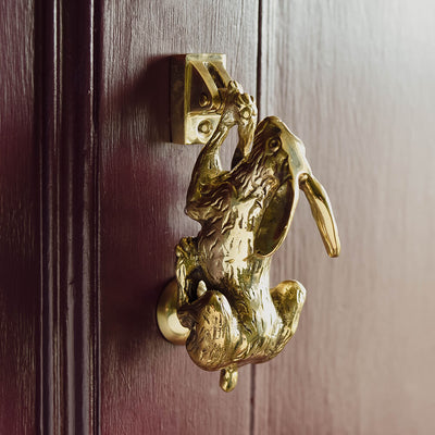 Hare door knocker on purple door