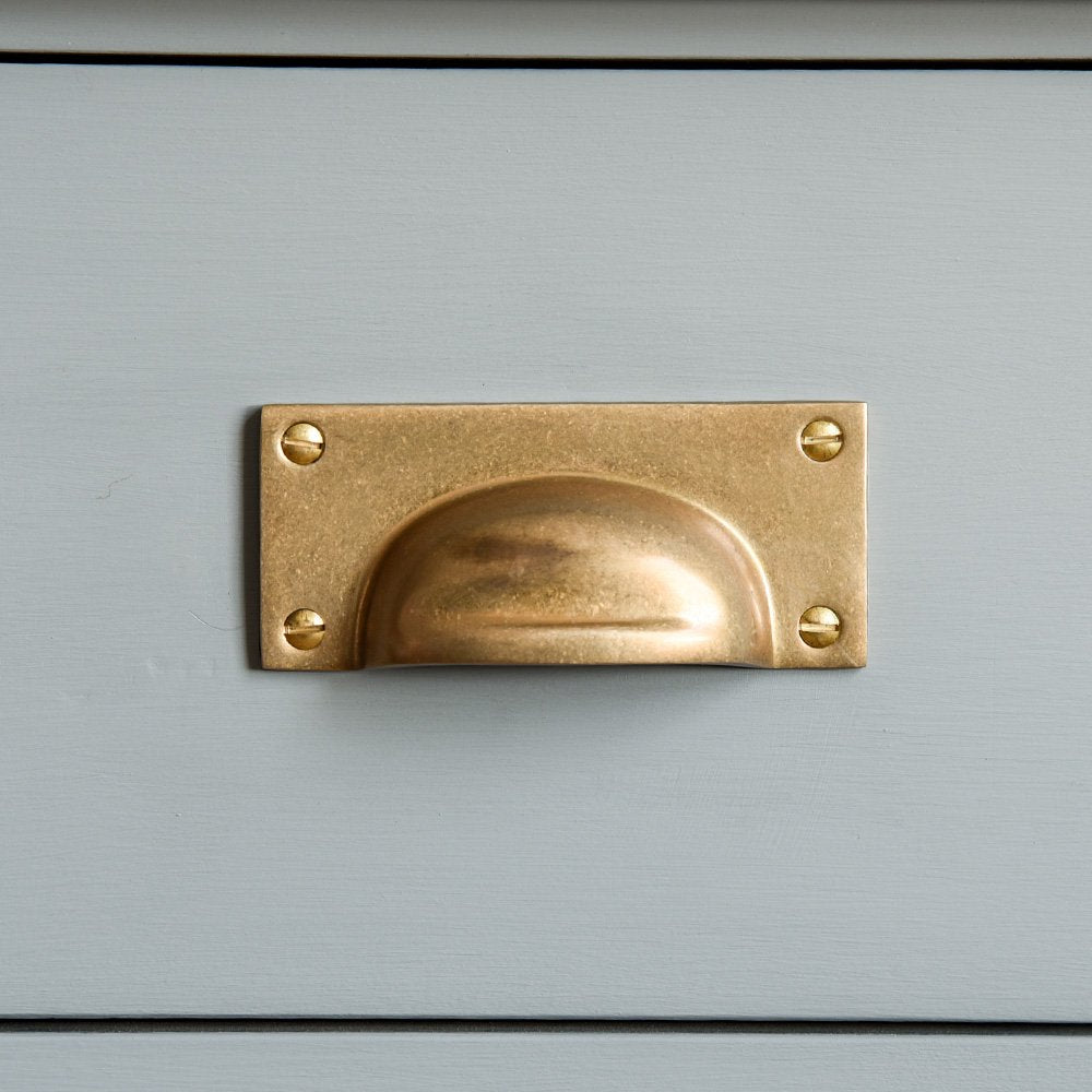 Rectangular Hooded Drawer Pull in an Aged Bras finish fitted to a blue/grey cabinet door