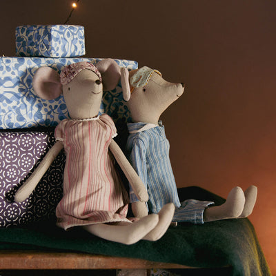 Maileg mice sat upon a sleigh wearing their bedtime clothes leaning against gifts