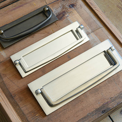 Photo showing variations in the handle form of the Marlborough letterplates seen here in various finsihes.
