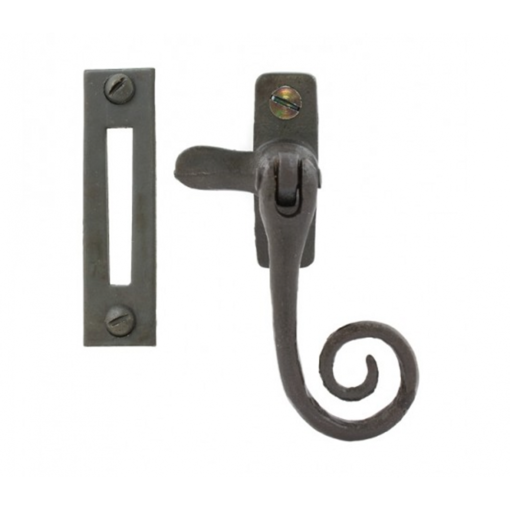 A monkeytail window fastener with a spiral handle design and lock keep in black beeswax positioned for a left hand window