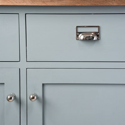Hooded drawer pull with card frame on kitchen drawer unit
