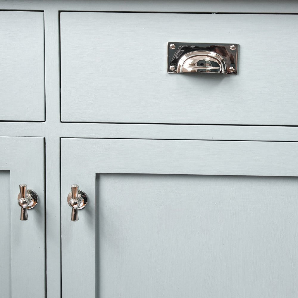 Hooded drawer pull and cabinet knobs on kitchen unit