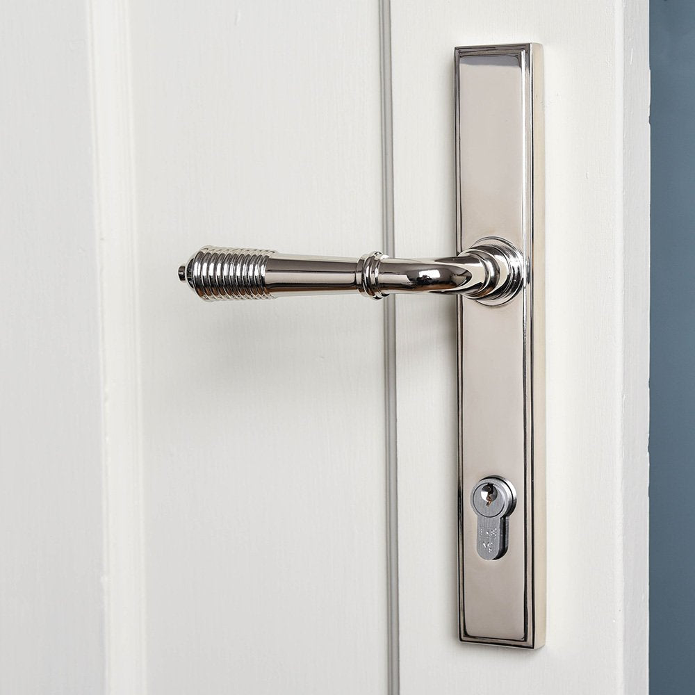A reeded lever handle with a euro lock and slimline backplate in a polished nickel finish