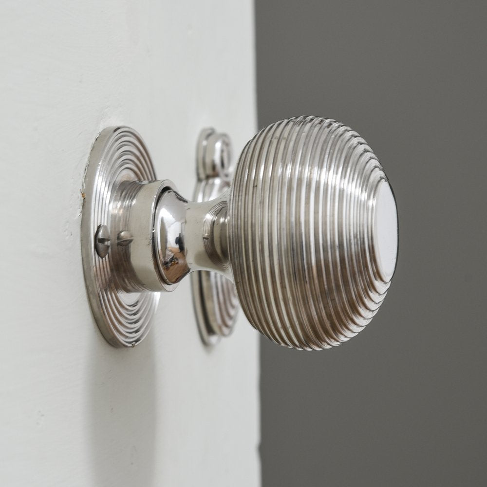 Nickel beehive door knob on white door