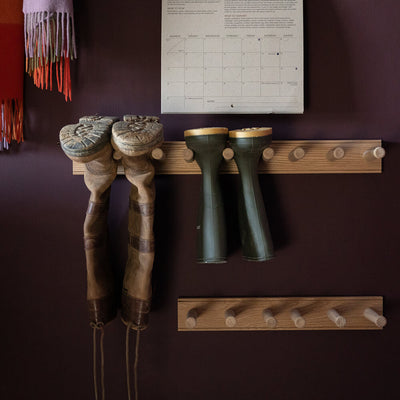 oak wellington boot holders on a wall