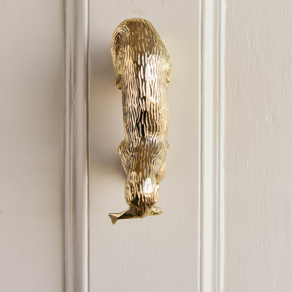 otter door knocker in brass seen from the top