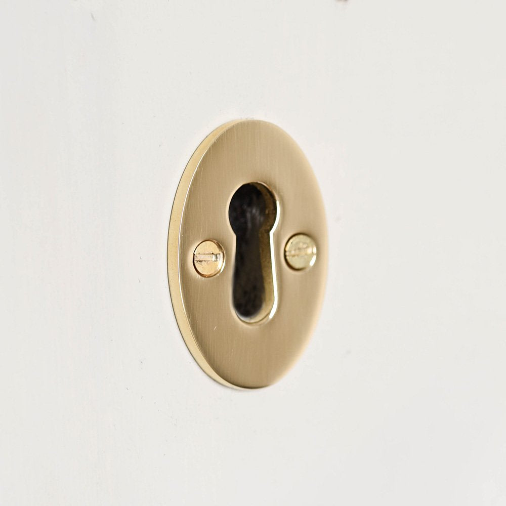 A plain solid brass oval keyhole escutcheon without a cover