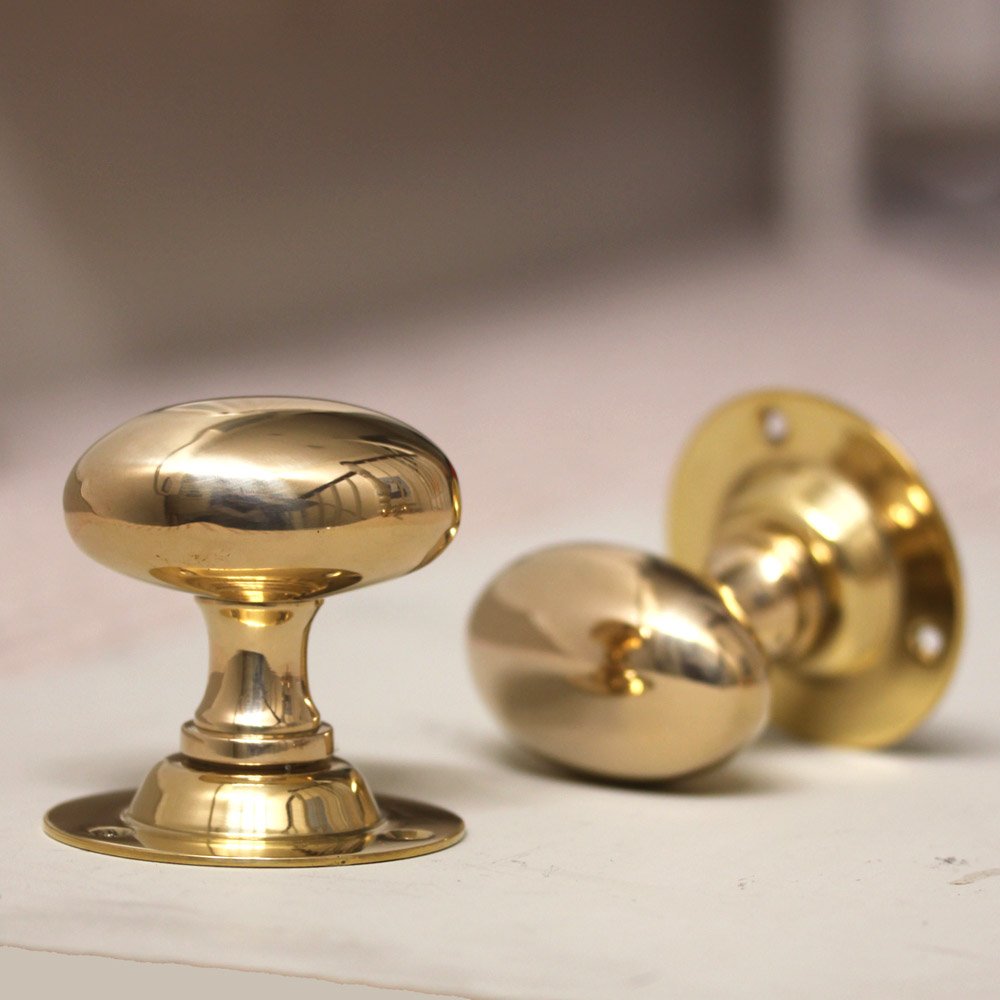 Pair of oval brass door knobs
