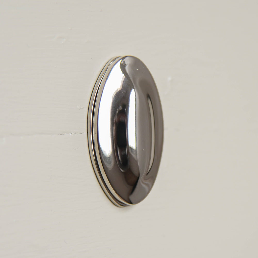 Oval keyhole cover with raised centre