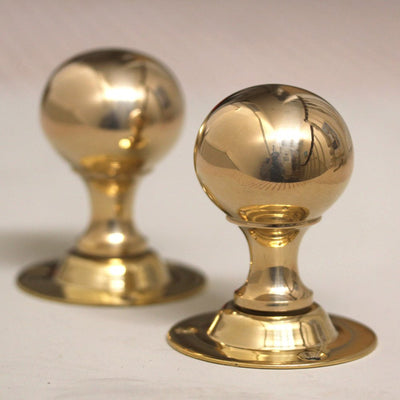 Pair of round brass door knobs