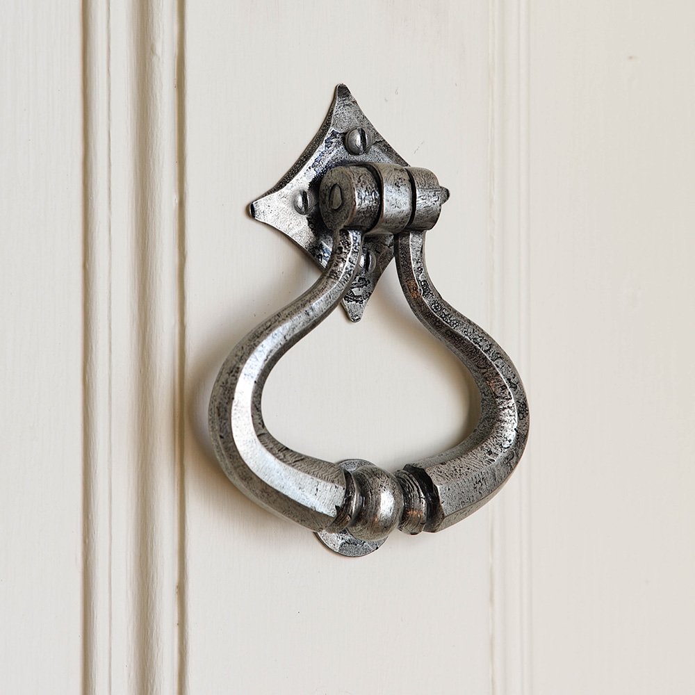 A Shakespear door knocker in a pewter finish fitted to a door