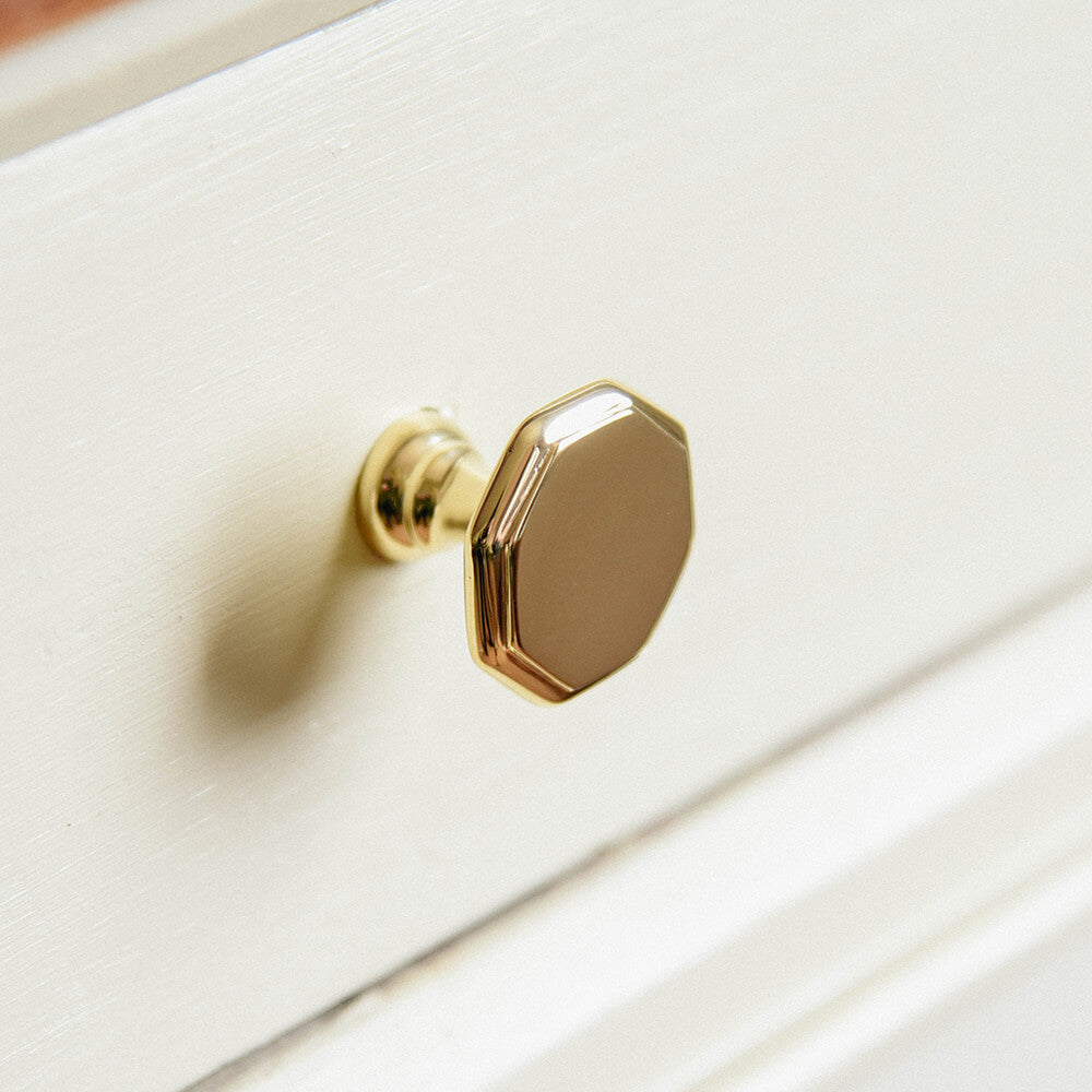 Octagonal cupboard knob in brass on kitchen units