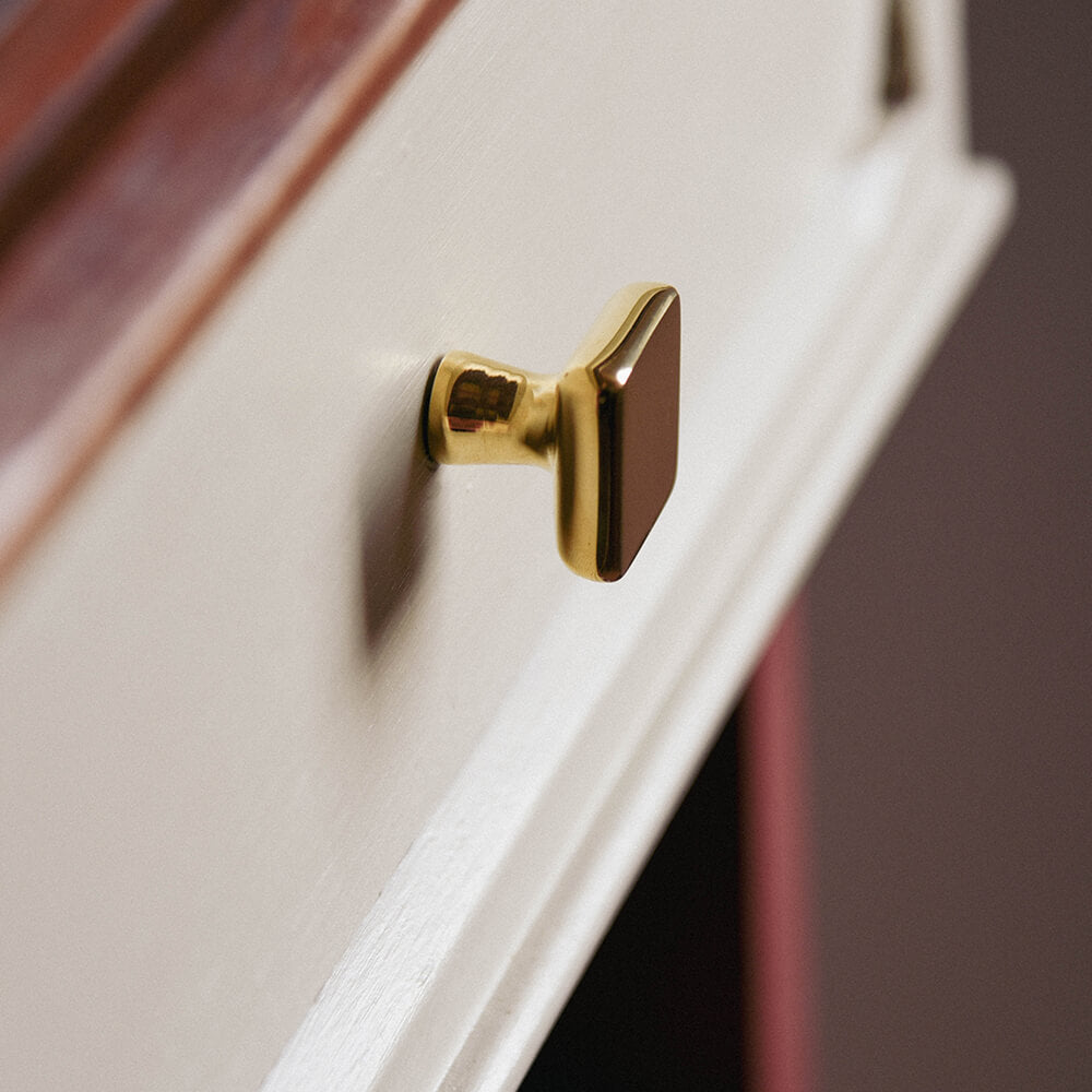 Polished Brass Plaza Cabinet Knob in profile on drawers