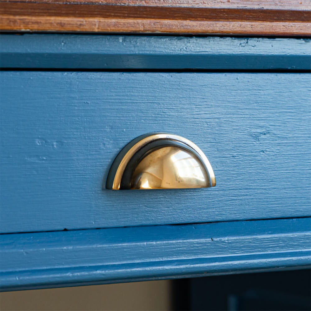 Regency Concealed Drawer Pull in Aged Brass on blue drawer