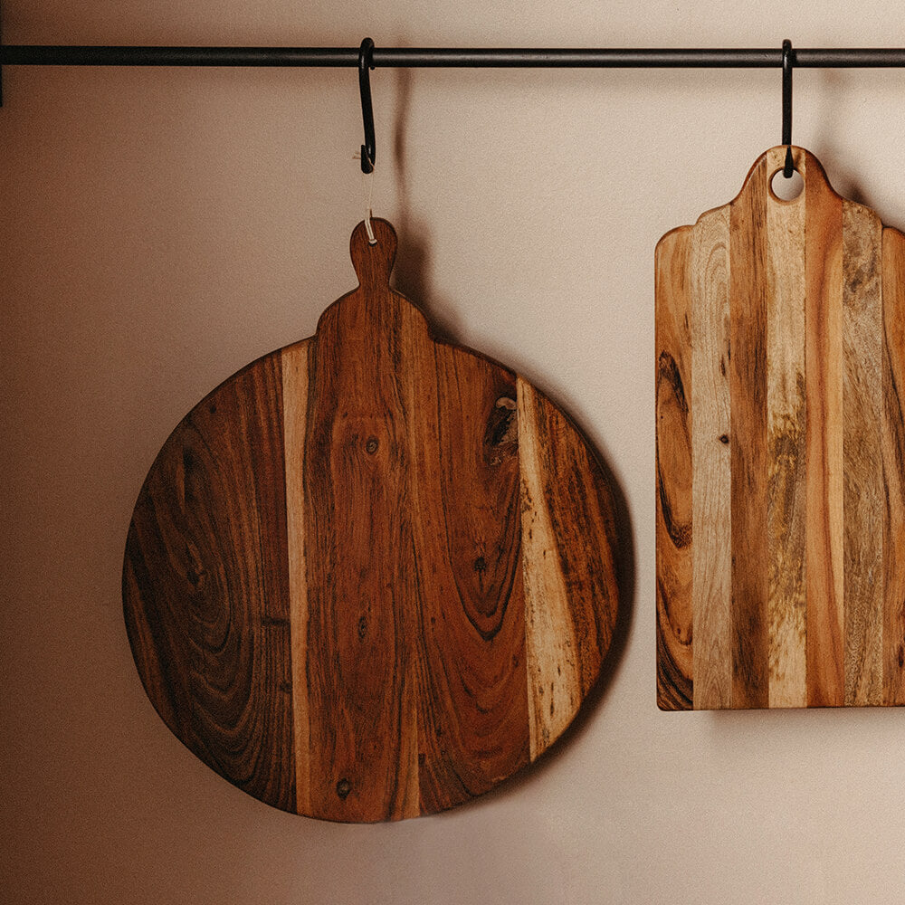 Round chopping board hung from hook rail