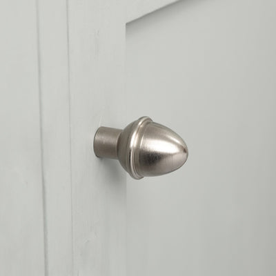 Acorn Shaped Cabinet Knob in a Satin Nickel Finish fitted to a white cupboard door