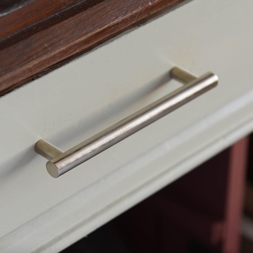 Satin nickel drum pull handle on a drawer front