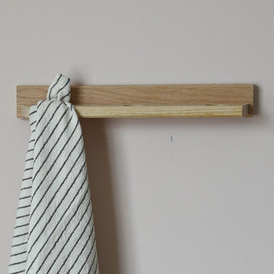 Front Facing view of a tea towel holder with a towel