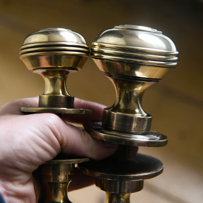Small and large polished antiqued brass regency bloxwich door knobs