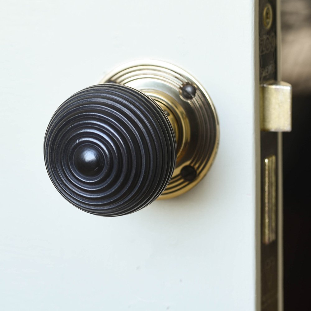 Solid ebony and brass beehive door knob front view