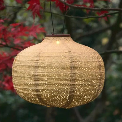 Pumpkin shaped solar lantern in tree
