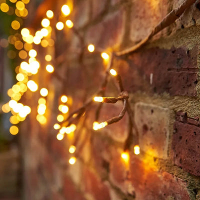 Solar Ivy Lights shown lit against brick wall