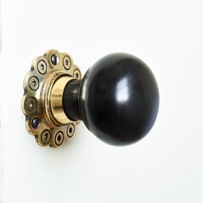 Solid ebony and brass bun door knob with petal backplate