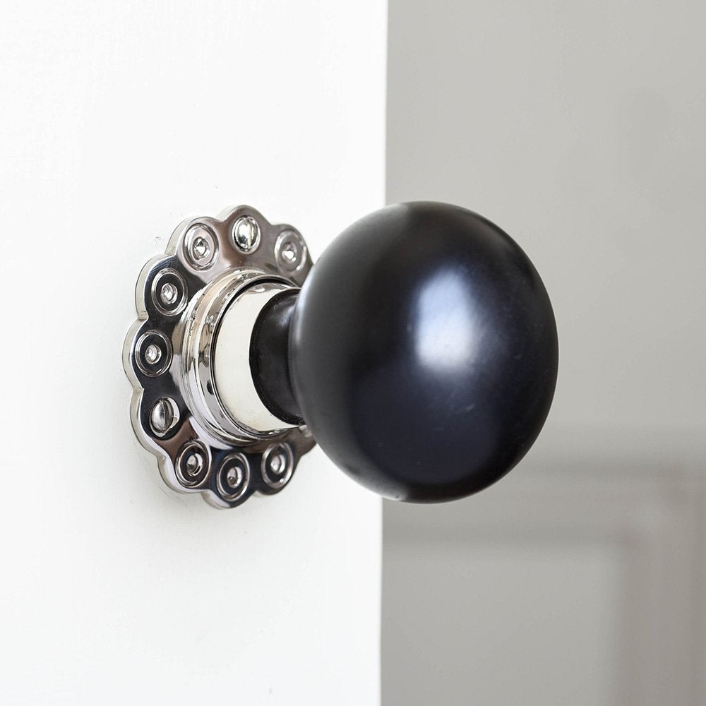 Solid ebony and nickel bun door knob with petal backplate