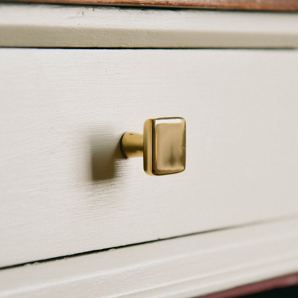 Brass Plaza square cupboard knob on cream drawers