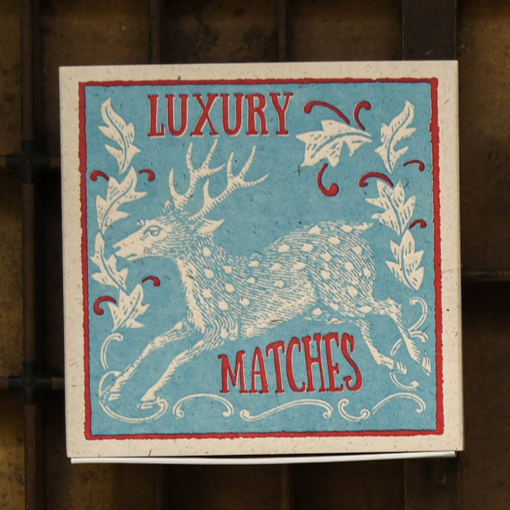 Luxury Match box in blue and red design featuring a stag illustration