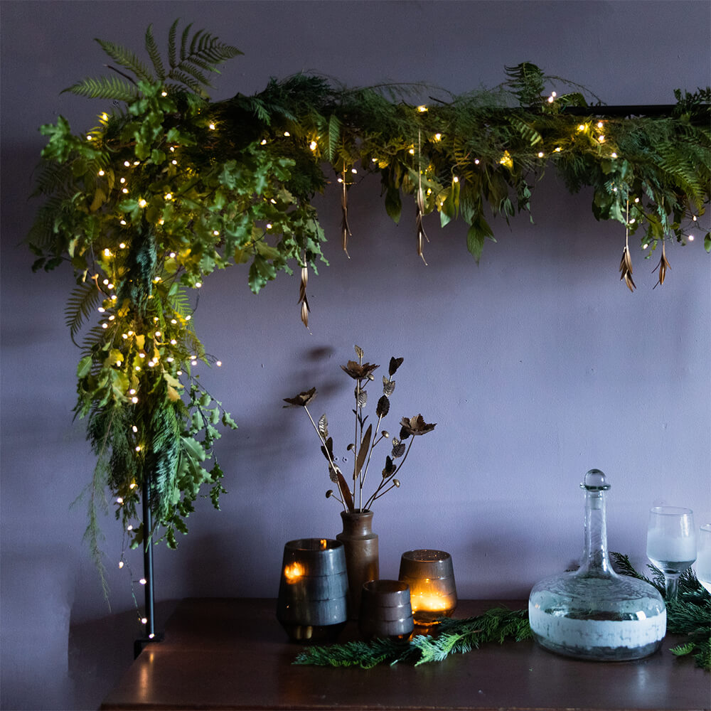 Table Frame with foliage over table of christmas decorations and accessories