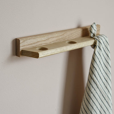 Side profile of a tea towel holder with towel