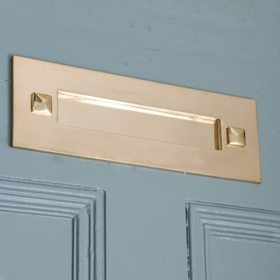 Traditional brass letterplate on blue door