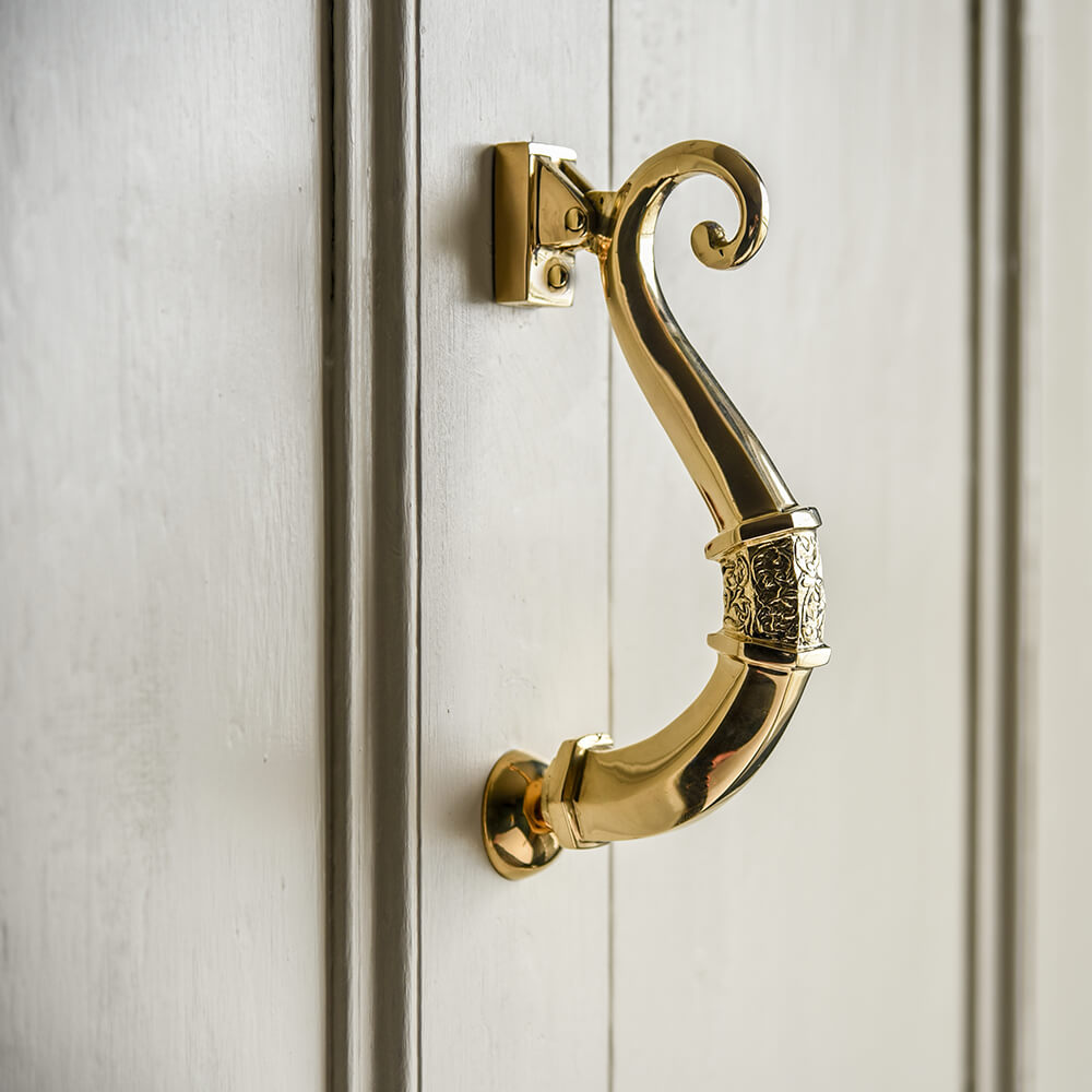 Brass Traditional Victorian Door Knocker on door