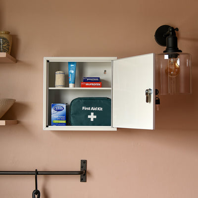 First aid cupboard seen open with accessories inside