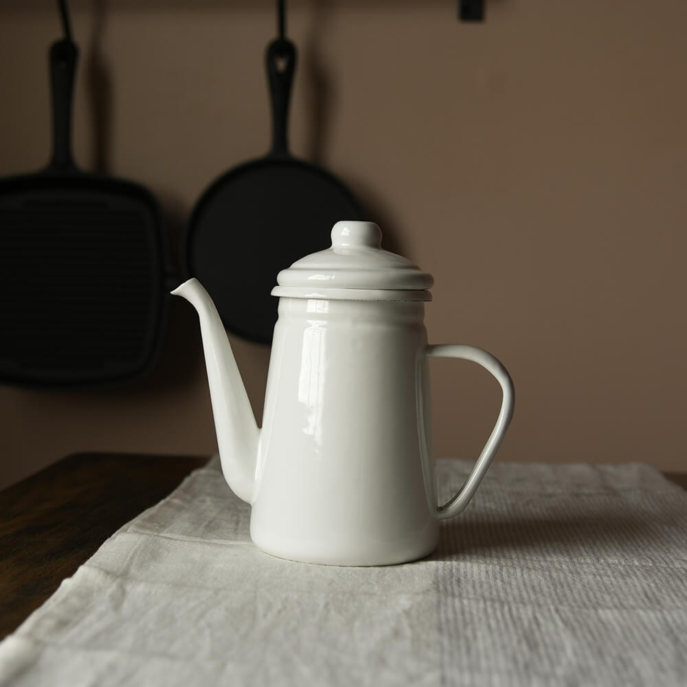 White Enamel Coffee Pot on a table