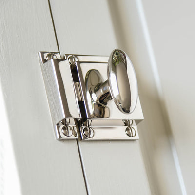 TRaditional cupboard catch in nickel with elongated oval knob