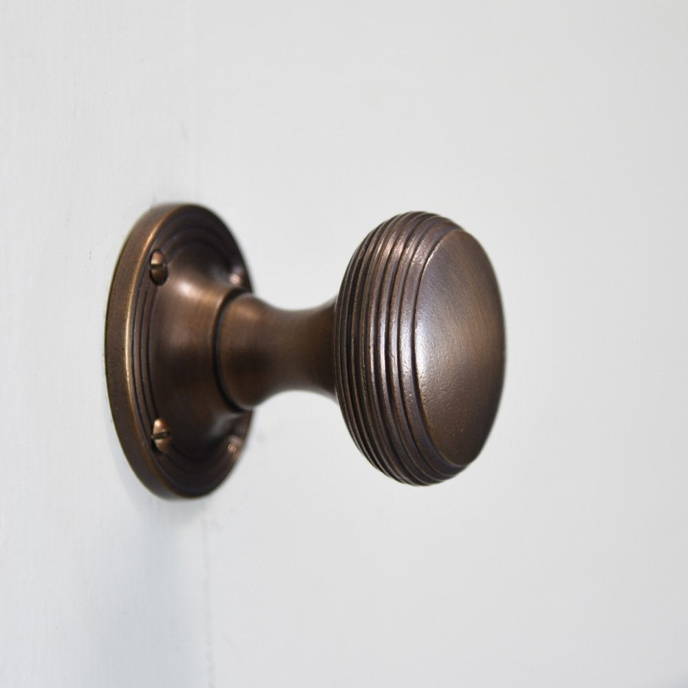 Solid brass Reeded Cushion Door Knobs in Distressed Antique finish.