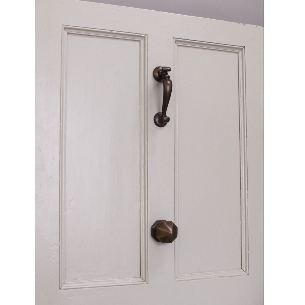 Distressed Antique Brass door furniture including Doctors Door Knocker and Pointed Octagonal Door Pull on white front door.
