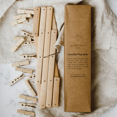bamboo peg airer folded down next to recyclable box packaging