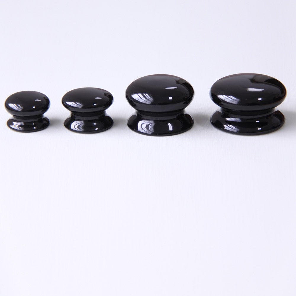 Black Ceramic Cabinet Knobs Lined Up in Small, Medium, Large and Extra Large