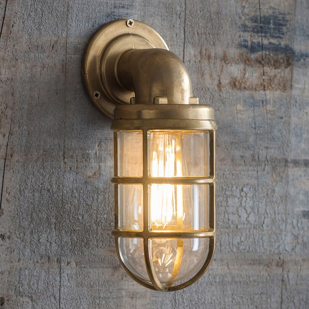 Brass downlight in naval style with cage around glass shade