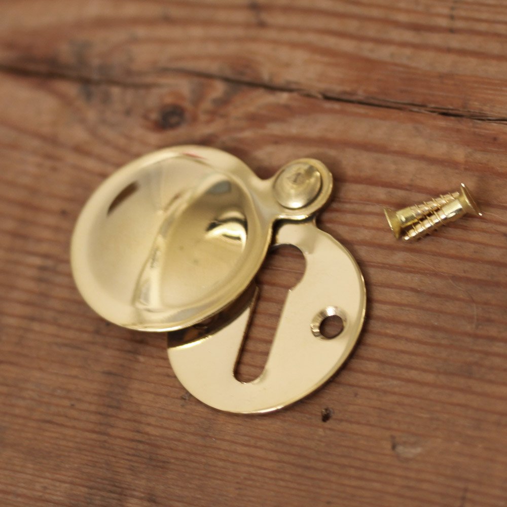 Plain Round Brass Escutcheon with cover slid open and two brass screws.