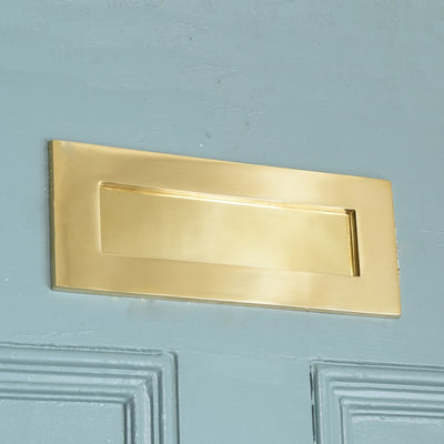 Alternate angle of Plain Polished Brass Letterplate on blue door.